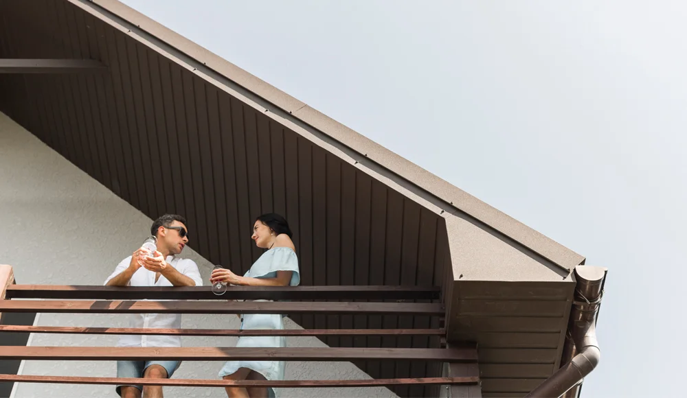 siding replacement - roofing repair services - home improvement - home repairs - couple - balcony - winter- cold months