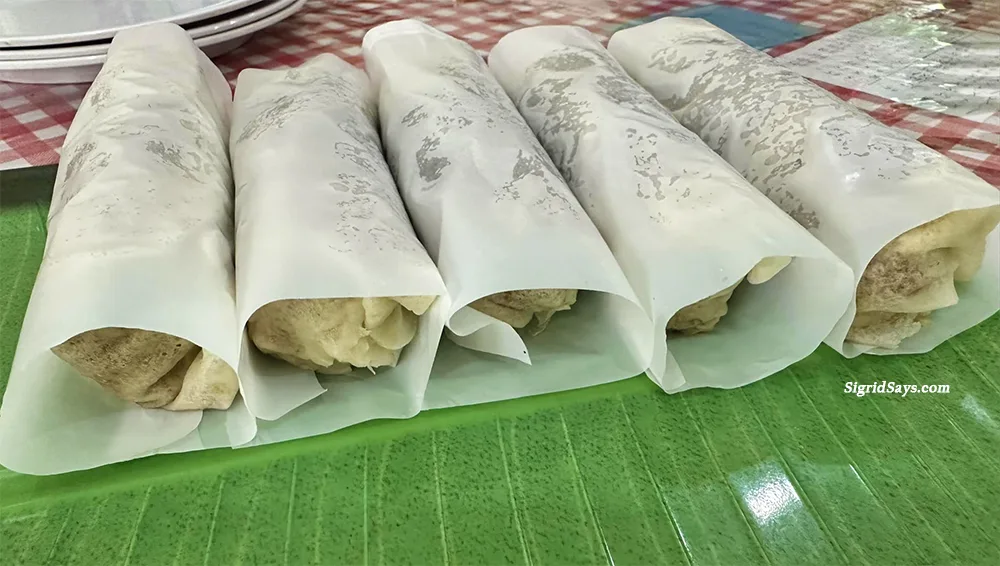 Kong's Chinese vegetable lumpia plated on a green faux leaf tray is made fresh everyday.