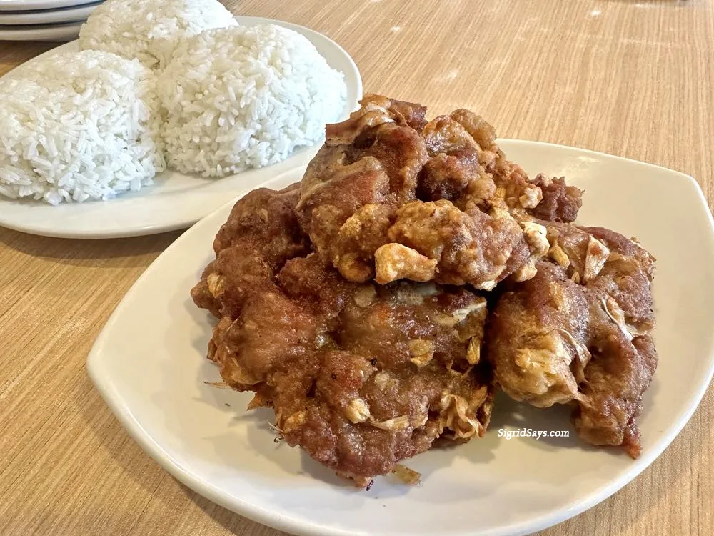 A serving of Luisa's fried garlic spareribs on a white plate. It is usually eaten with rice.