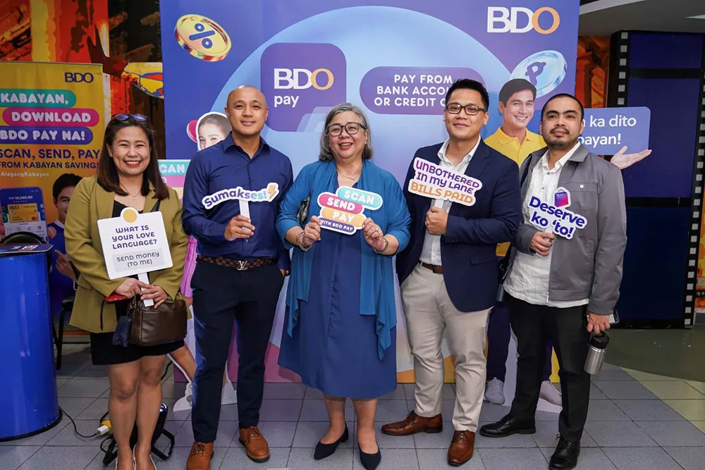 Ms. Genie T. Gloria, Senior Vice President and Head of BDO Remittance (center), stands with members of the Digital Customer Experience team. 